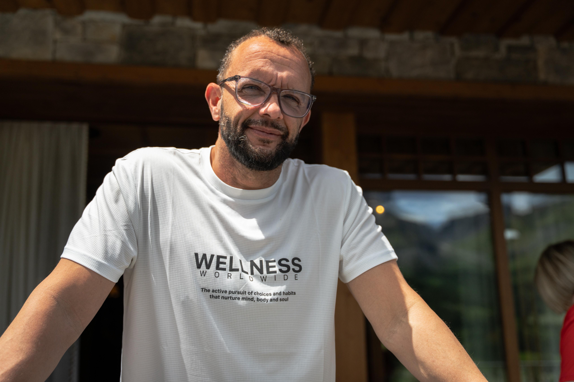 Jamie Baulch in a white Wellness Worldwide T-shirt in Switzerland